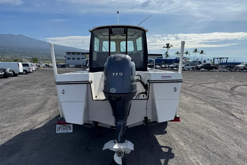 Slide: The Image of 2024 Arima Sea Chaser 19 Yellowtail Edition with Yamaha 115 engine, parked on gravel. - 10