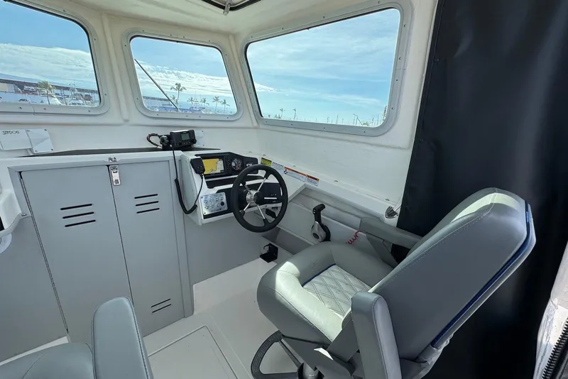 Slide: The Image of 2024 Arima Sea Chaser 19 Yellowtail Edition boat interior with steering wheel and controls. - 15