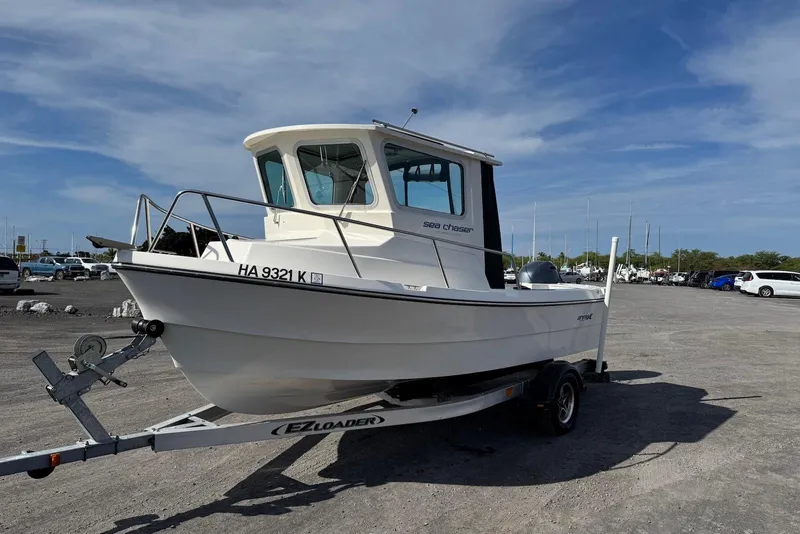 Slide: The Image of 2024 Arima Sea Chaser 19 Yellowtail Edition boat on trailer in parking lot. - 7