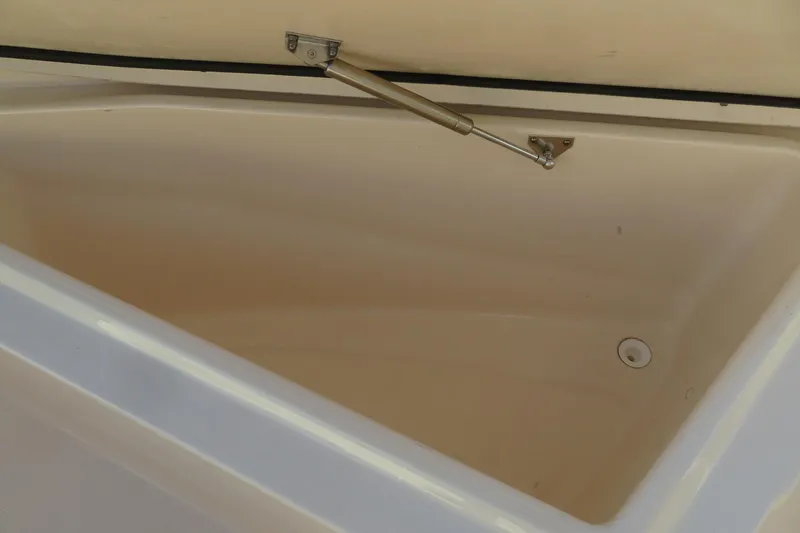 Slide: The Image of 2016 Grady-White Fisherman 209 boat interior with cushioned seating and storage. - 14