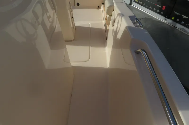 Slide: The Image of 2016 Grady-White Fisherman 209 boat interior with seating and cooler. - 19