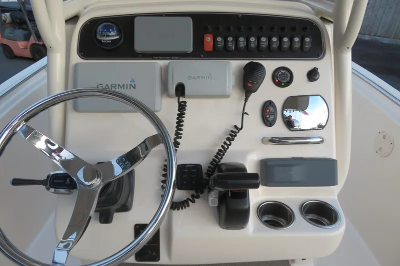 Slide: The Image of 2016 Grady-White Fisherman 209 boat interior with beige seating and Yamaha 200 engine. - 36