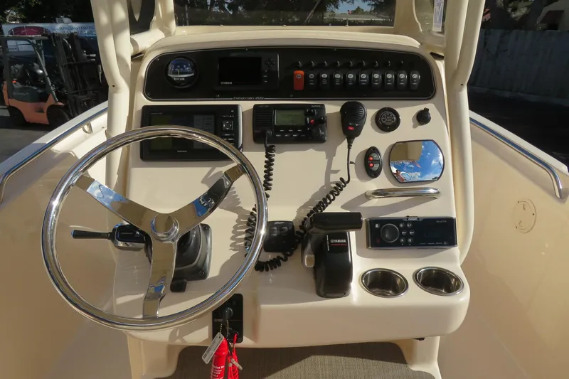 Slide: The Image of 2016 Grady-White Fisherman 209 boat interior with beige seating and steering wheel. - 37