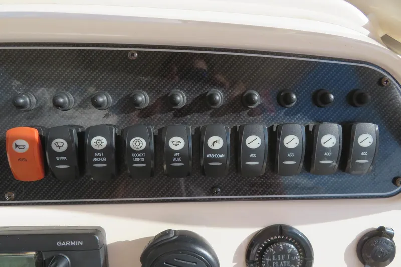 Slide: The Image of Garmin VHF 100 radio on 2016 Grady-White Fisherman 209 boat dashboard. - 42