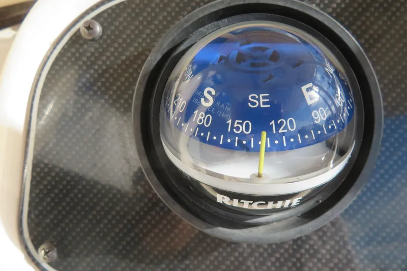 Slide: The Image of 2016 Grady-White Fisherman 209 boat with Yamaha engine, parked near a gated area. - 48