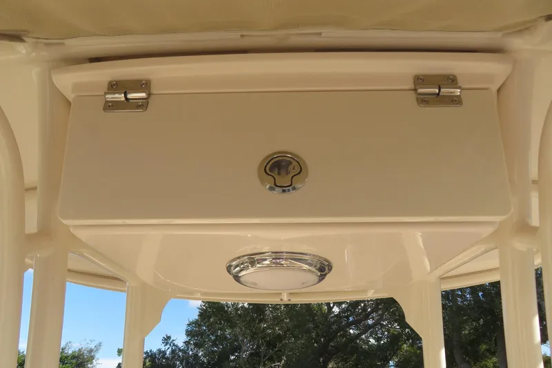 Slide: The Image of 2016 Grady-White Fisherman 209 with Yamaha 200 outboard motor, docked near a fence. - 54