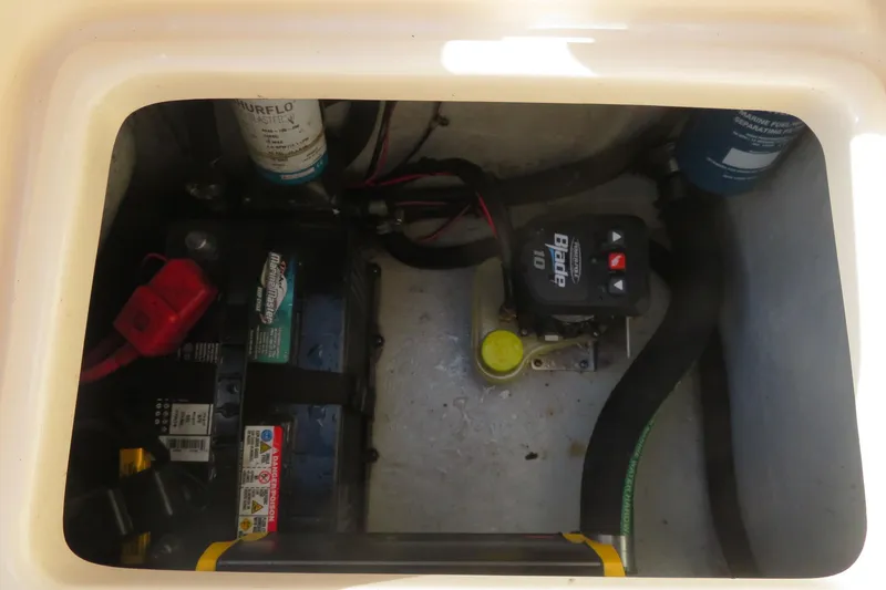 Slide: The Image of 2016 Grady-White Fisherman 209 boat battery compartment with wiring and components. - 64