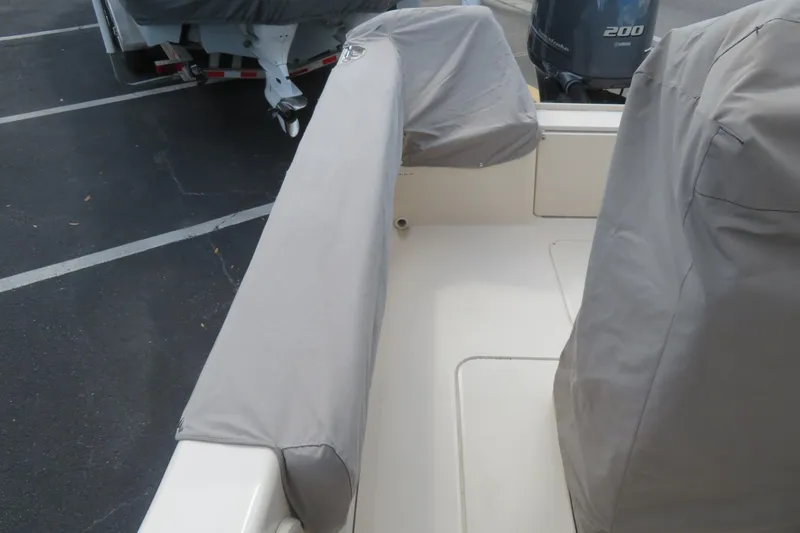 Slide: The Image of 2016 Grady-White Fisherman 209 boat with protective covers in a parking lot. - 72