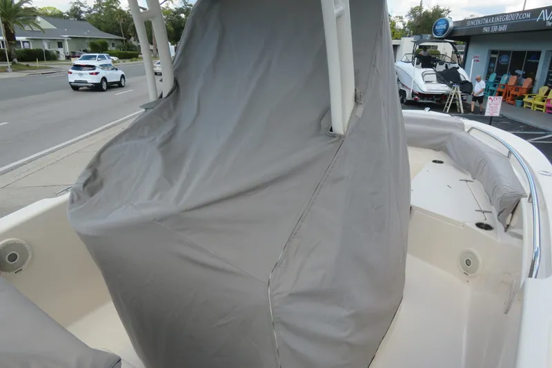 Slide: The Image of 2016 Grady-White Fisherman 209 boat with protective cover, parked on a street. - 76