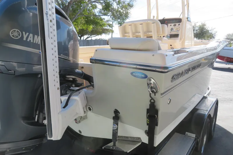 Slide: The Image of 2016 Grady-White Fisherman 209 boat with Yamaha engine, parked outdoors under a cloudy sky. - 9