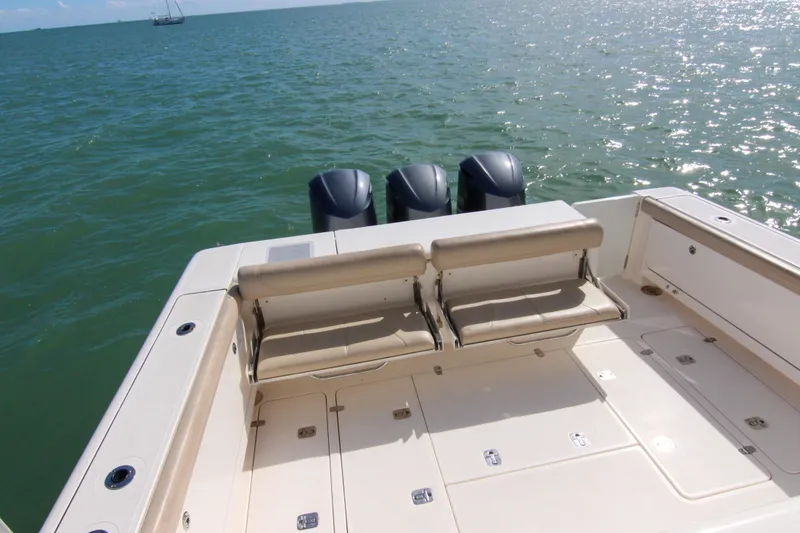 Slide: The Image of 2016 Pursuit OS 385 Offshore boat deck with seating, overlooking calm ocean waters. - 37