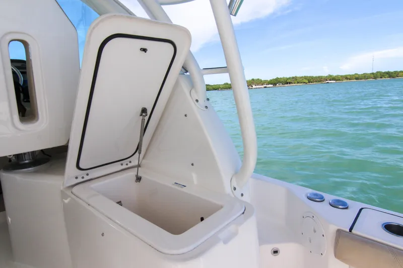 Slide: The Image of 2016 Pursuit OS 385 Offshore boat with open storage compartment, ocean view. - 41