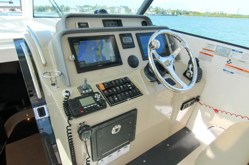 Slide: The Image of Helm of 2016 Pursuit OS 385 Offshore boat with navigation equipment and steering wheel. - 47
