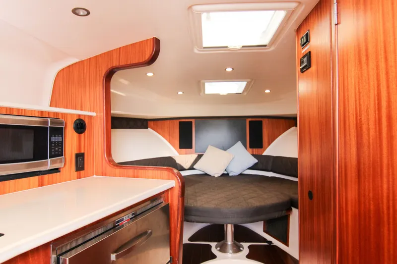 Slide: The Image of Luxurious interior of 2016 Pursuit OS 385 Offshore boat with cozy bed and modern amenities. - 50