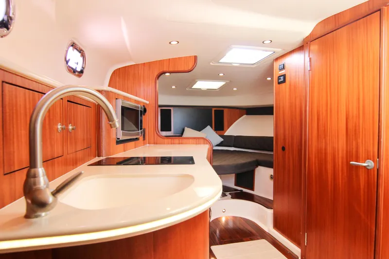Slide: The Image of Luxurious interior of 2016 Pursuit OS 385 Offshore boat with modern kitchen and cozy seating. - 51