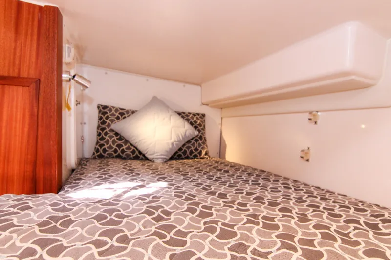 Slide: The Image of Cozy cabin bed in 2016 Pursuit OS 385 Offshore boat with patterned bedding. - 54