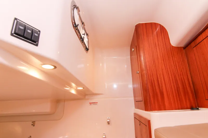 Slide: The Image of 2016 Pursuit OS 385 Offshore cabin interior with wood cabinetry and recessed lighting. - 55