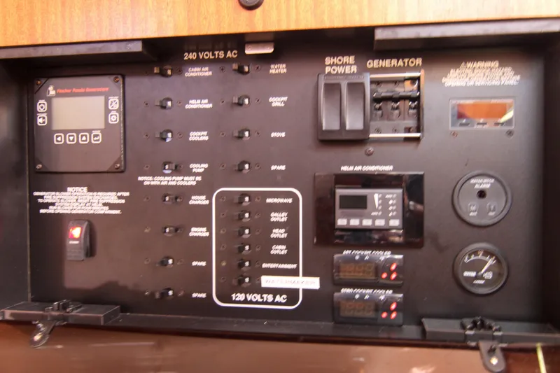 Slide: The Image of Electrical control panel of a 2016 Pursuit OS 385 Offshore boat, featuring switches and gauges. - 59