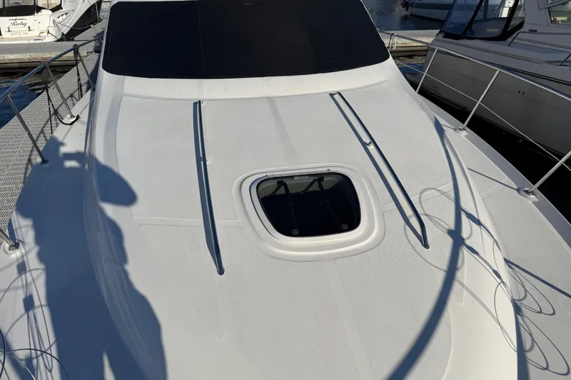 Slide: The Image of 2006 Sea Ray 44 Sedan Bridge yacht deck with hatch, docked at marina. - 100