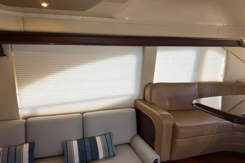Slide: The Image of Luxurious interior of 2006 Sea Ray 44 Sedan Bridge yacht with leather seating and elegant decor. - 11