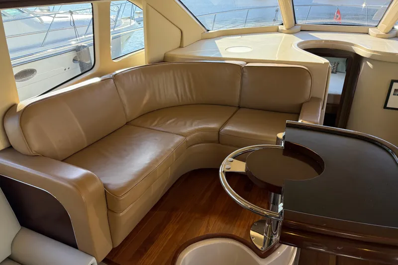 Slide: The Image of Luxurious interior of 2006 Sea Ray 44 Sedan Bridge with leather seating and wooden accents. - 18