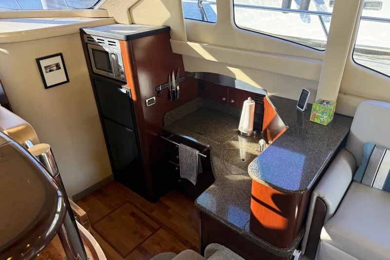 Slide: The Image of Interior of 2006 Sea Ray 44 Sedan Bridge yacht with modern kitchen amenities. - 22