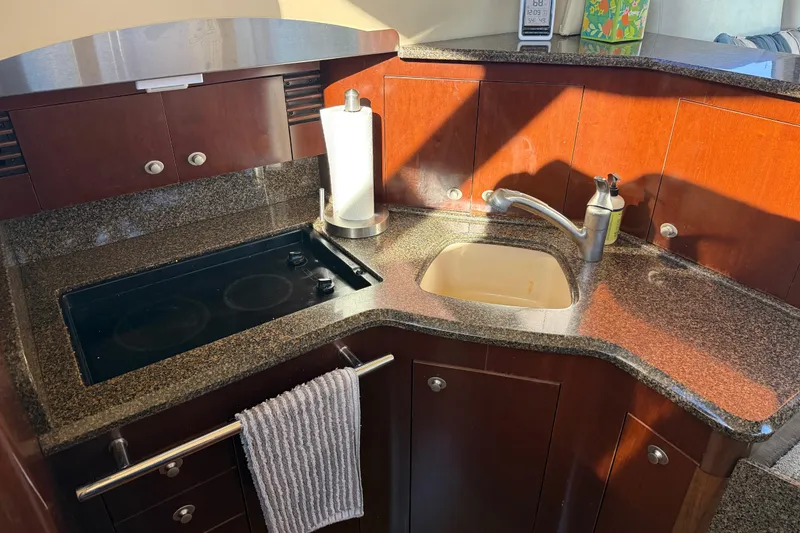 Slide: The Image of Luxurious 2006 Sea Ray 44 Sedan Bridge yacht kitchen with granite countertops and modern amenities. - 25