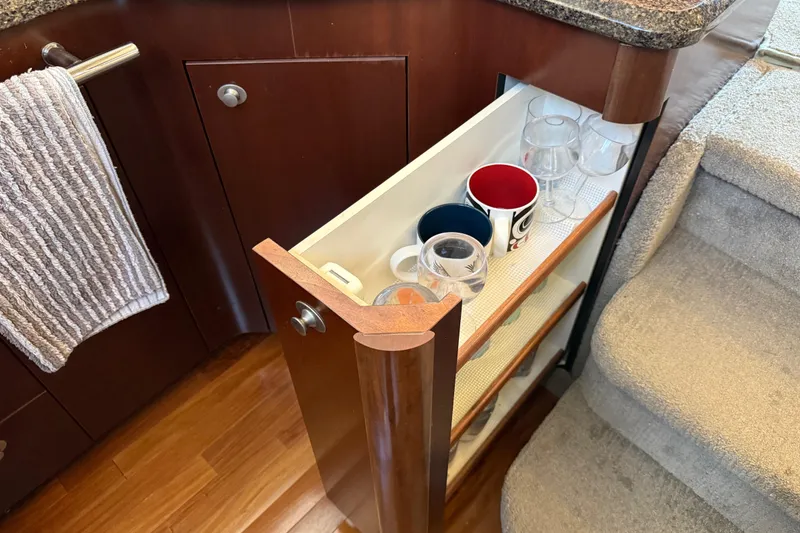 Slide: The Image of Pull-out cabinet with mugs and glasses in 2006 Sea Ray 44 Sedan Bridge yacht. - 29