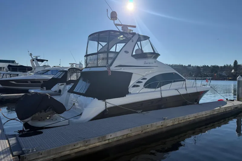 Slide: The Image of 2006 Sea Ray 44 Sedan Bridge yacht docked in sunny marina setting. - 3
