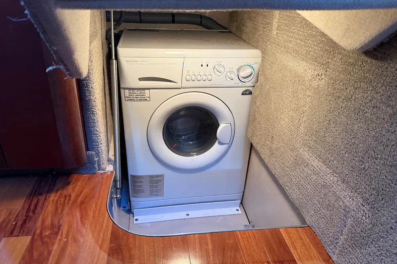 Slide: The Image of Washing machine inside 2006 Sea Ray 44 Sedan Bridge yacht, carpeted interior, wooden floor. - 31