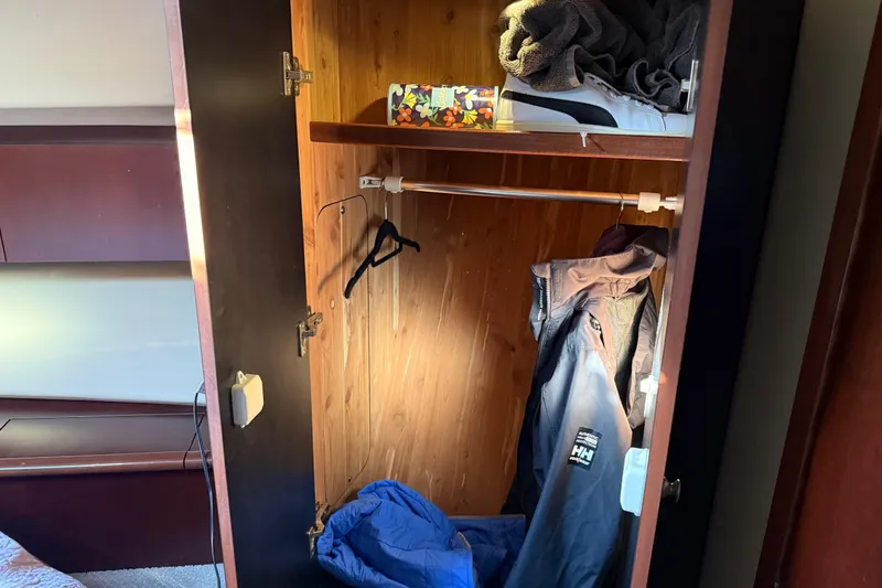 Slide: The Image of Open closet on 2006 Sea Ray 44 Sedan Bridge with clothes and shoes inside. - 38