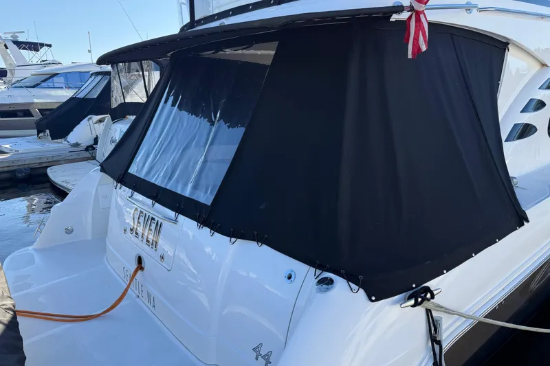 Slide: The Image of 2006 Sea Ray 44 Sedan Bridge yacht docked with black canvas cover. - 4