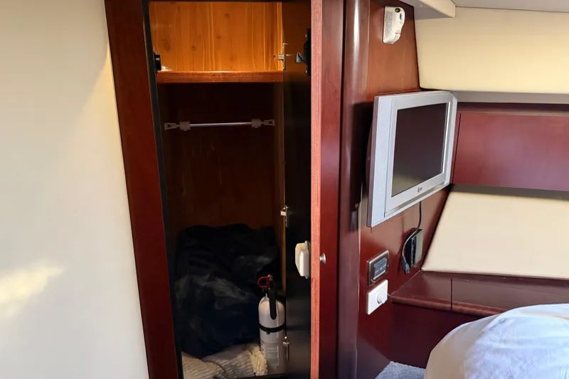 Slide: The Image of Interior of 2006 Sea Ray 44 Sedan Bridge with closet and wall-mounted TV. - 40