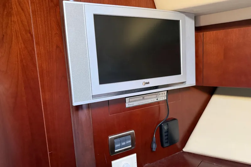 Slide: The Image of Flat-screen TV and DVD player on 2006 Sea Ray 44 Sedan Bridge yacht interior. - 41