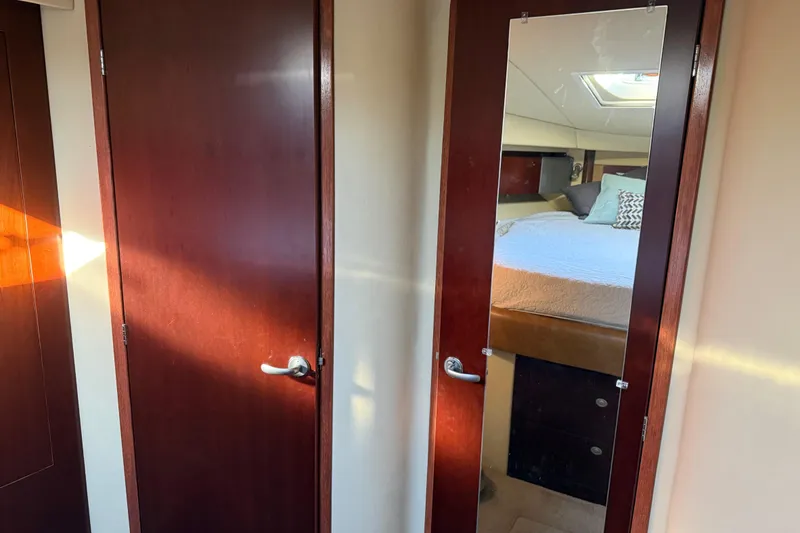 Slide: The Image of Interior of 2006 Sea Ray 44 Sedan Bridge with mirrored door and cozy bedroom. - 42