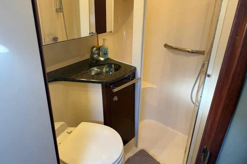 Slide: The Image of Luxurious bathroom in 2006 Sea Ray 44 Sedan Bridge yacht with shower and sink. - 44