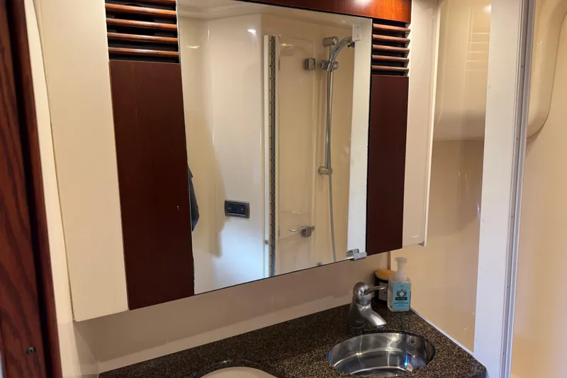 Slide: The Image of Bathroom interior of 2006 Sea Ray 44 Sedan Bridge yacht, featuring sink and mirror. - 46