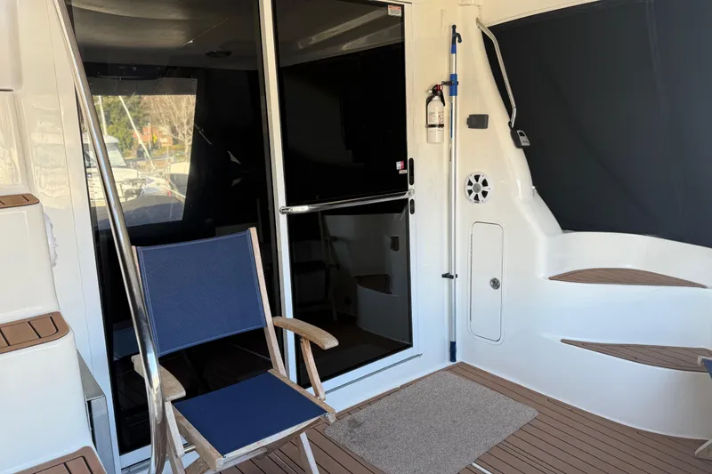 Slide: The Image of 2006 Sea Ray 44 Sedan Bridge yacht interior with chair and sliding door. - 5