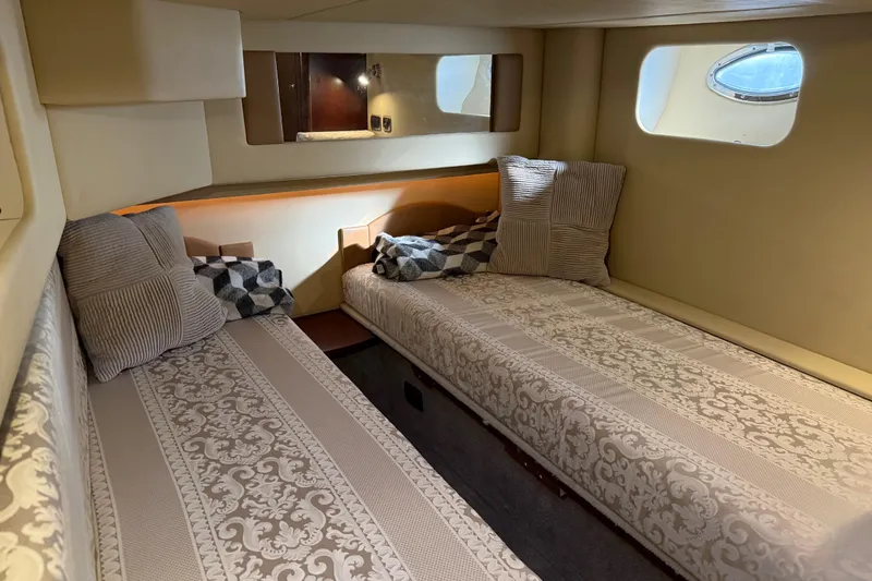Slide: The Image of 2006 Sea Ray 44 Sedan Bridge cabin with twin beds and decorative pillows. - 51