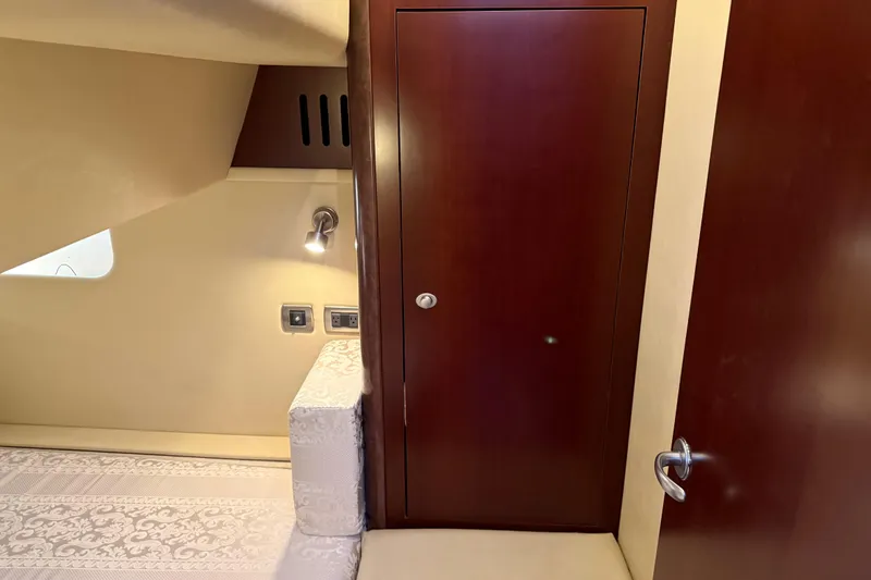 Slide: The Image of Interior of 2006 Sea Ray 44 Sedan Bridge with wood paneling and cozy lighting. - 52