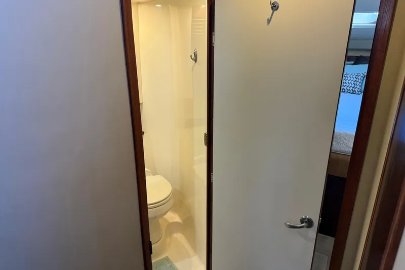 Slide: The Image of Bathroom interior of 2006 Sea Ray 44 Sedan Bridge yacht, featuring toilet and shower. - 54