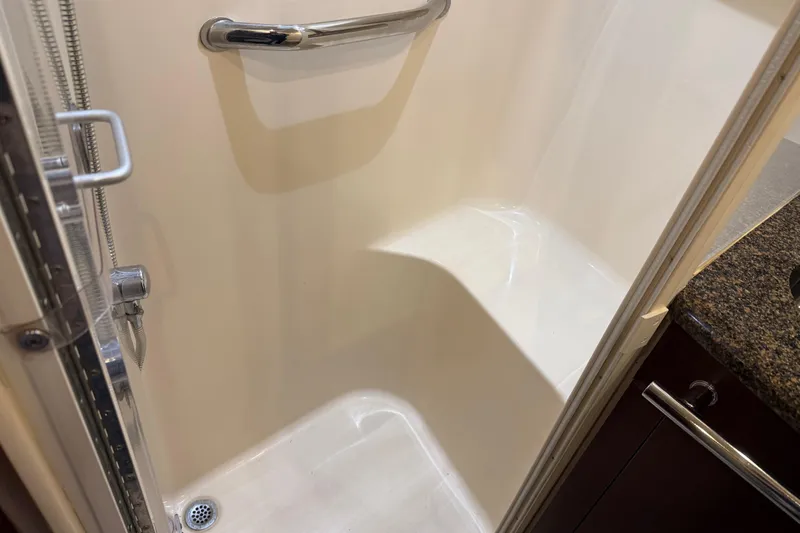 Slide: The Image of Shower area in 2006 Sea Ray 44 Sedan Bridge yacht with grab bar and handheld showerhead. - 57
