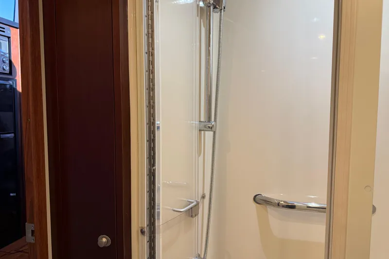 Slide: The Image of Shower area inside 2006 Sea Ray 44 Sedan Bridge yacht, featuring sleek design and chrome fixtures. - 58