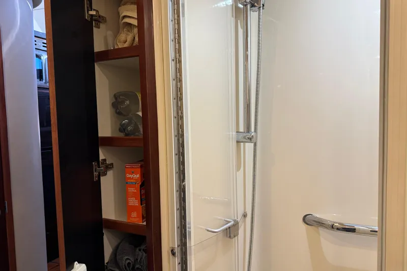 Slide: The Image of Shower area and storage cabinet inside 2006 Sea Ray 44 Sedan Bridge yacht. - 59
