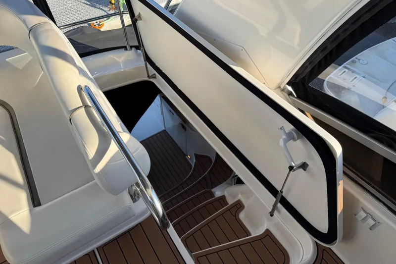 Slide: The Image of 2006 Sea Ray 44 Sedan Bridge interior with open hatch and sleek seating. - 76