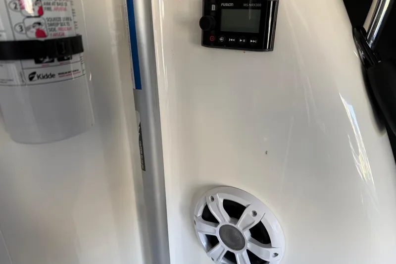 Slide: The Image of 2006 Sea Ray 44 Sedan Bridge interior with fire extinguisher, speaker, and control panel. - 80