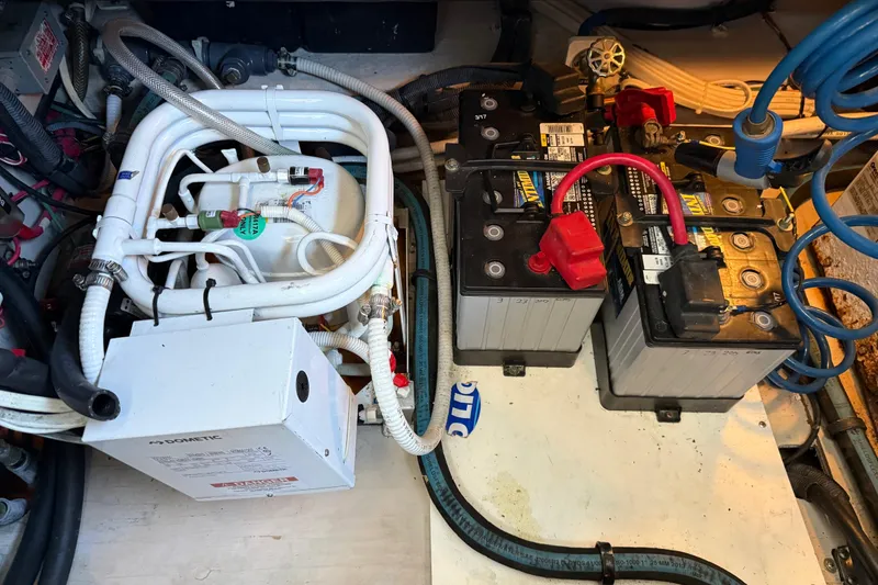 Slide: The Image of Engine room of 2006 Sea Ray 44 Sedan Bridge with batteries and plumbing components. - 87