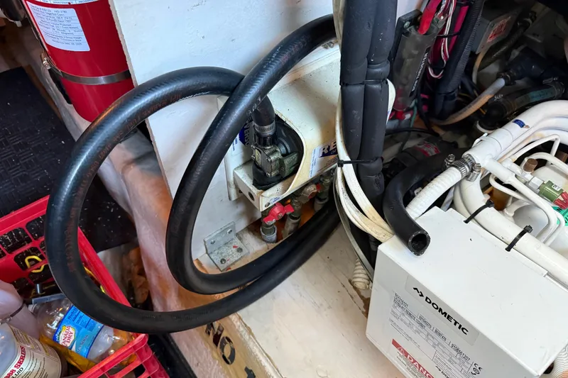 Slide: The Image of Engine room of 2006 Sea Ray 44 Sedan Bridge with hoses and equipment. - 89