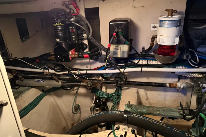 Slide: The Image of Engine room of 2006 Sea Ray 44 Sedan Bridge with wiring and fuel system components. - 90