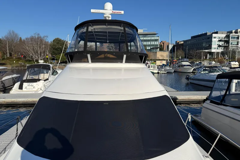 Slide: The Image of 2006 Sea Ray 44 Sedan Bridge yacht docked at marina, surrounded by other boats. - 99